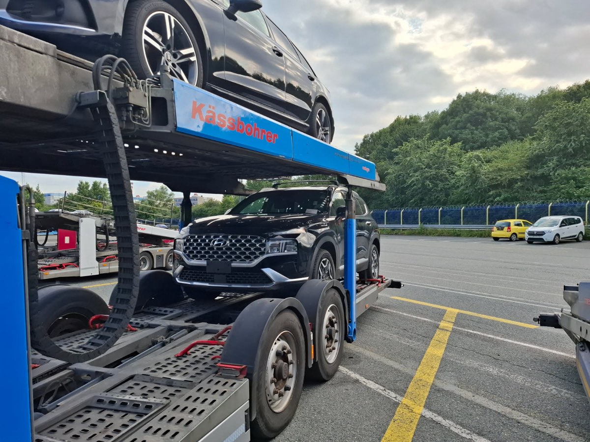 A black Hyundai Santa Fe loaded onto a two-tier car transporter at Bremerhaven port